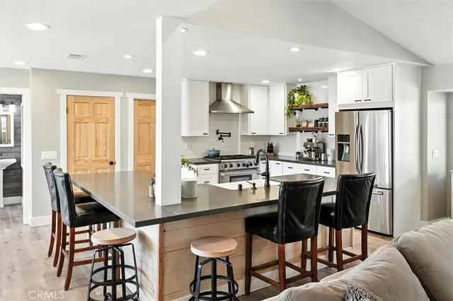 a utility room with a refrigerator and washer