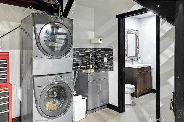 a view of a patio with table and chairs potted plants with wooden floor and fence