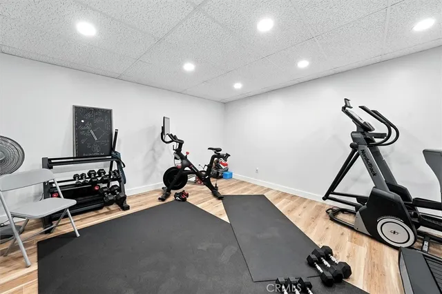 a view of a patio with couches chairs potted plants and lake view