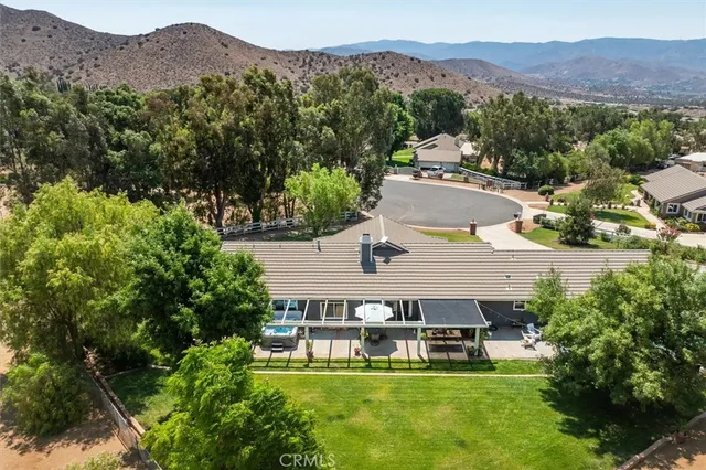 an aerial view of a house with a yard