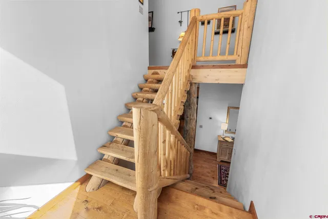 a view of entryway and hall with wooden floor