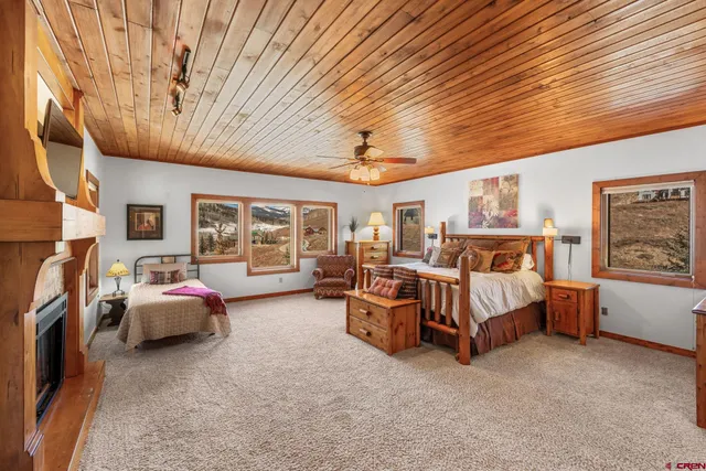 a bedroom with furniture and large window