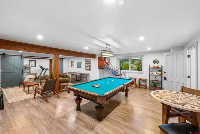 a living room with furniture a table and wooden floor
