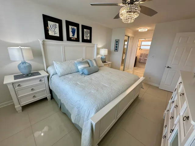 a bedroom with a bed and a flat tv screen on dresser
