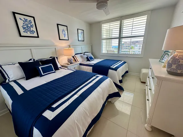 a bedroom with two beds and painting on the wall