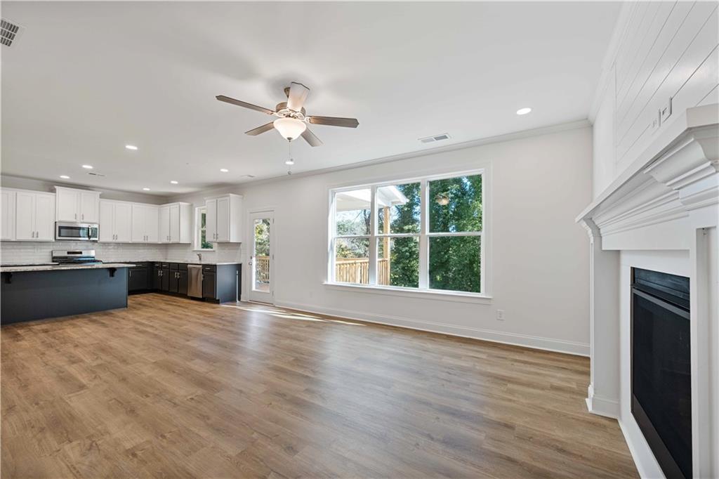 2126 Seavey Drive Decatur, GA 30032 - Photo 11 of 40 a view of kitchen with kitchen island a sink wooden floor and a fireplace
