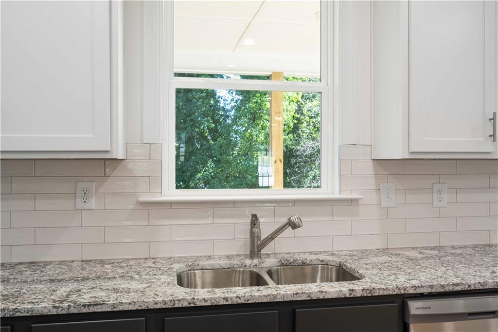 2126 Seavey Drive Decatur, GA 30032 - Photo 16 of 40 a kitchen with granite countertop a sink and a window