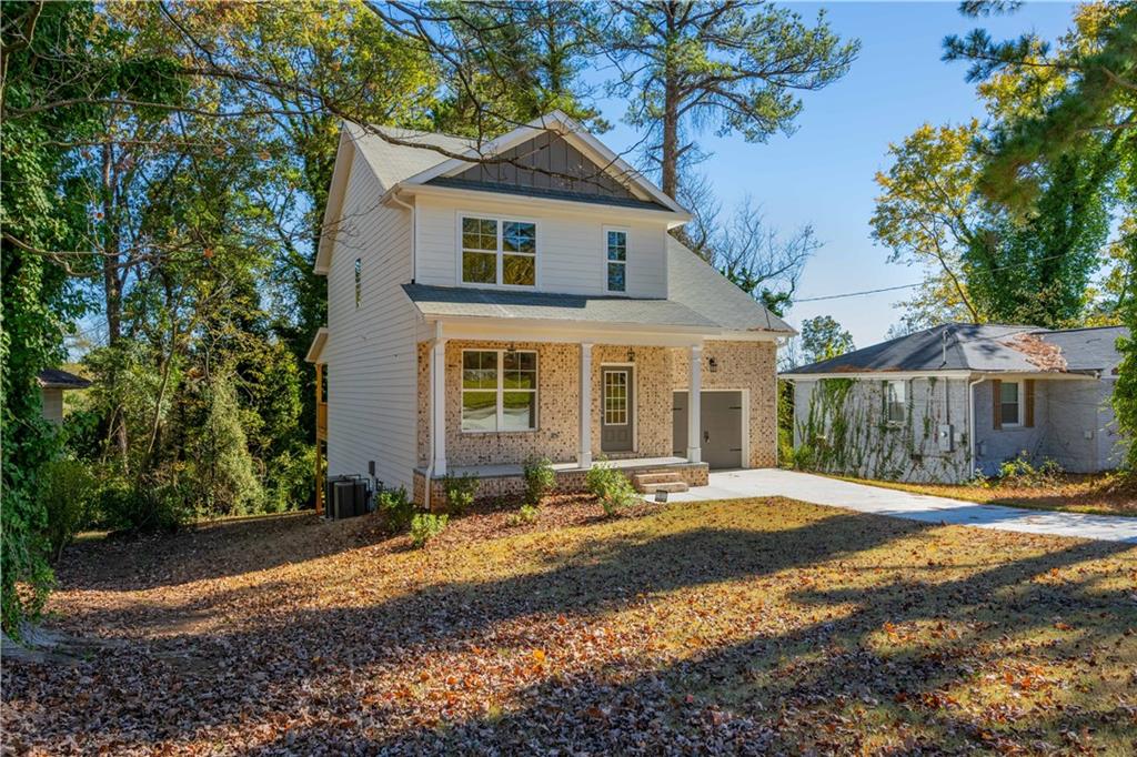 2126 Seavey Drive Decatur, GA 30032 - Photo 2 of 40 a front view of a house with a yard and trees