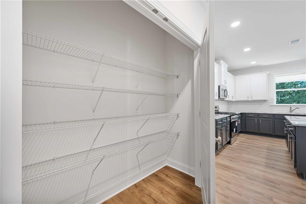 2126 Seavey Drive Decatur, GA 30032 - Photo 21 of 40 a kitchen with stainless steel appliances cabinets a wooden floor and a sink