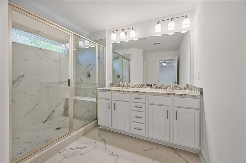 2126 Seavey Drive Decatur, GA 30032 - Photo 25 of 40 a bathroom with a shower sink and mirror