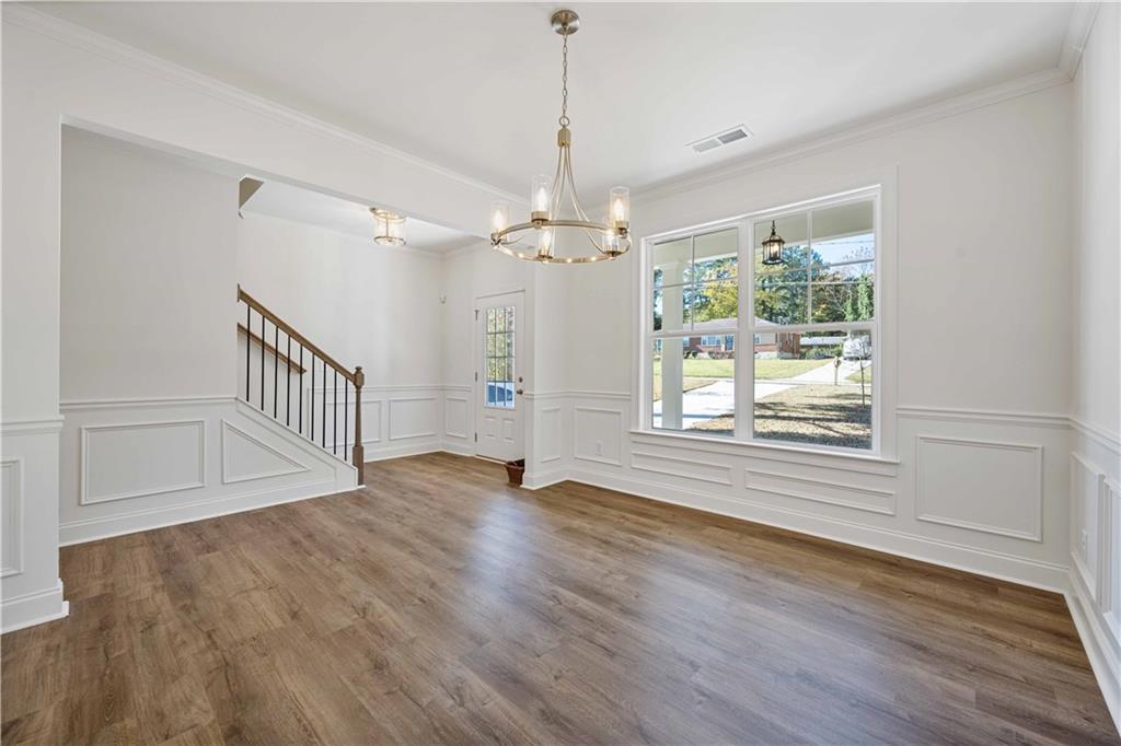 2126 Seavey Drive Decatur, GA 30032 - Photo 8 of 40 a view of an empty room with wooden floor and a window