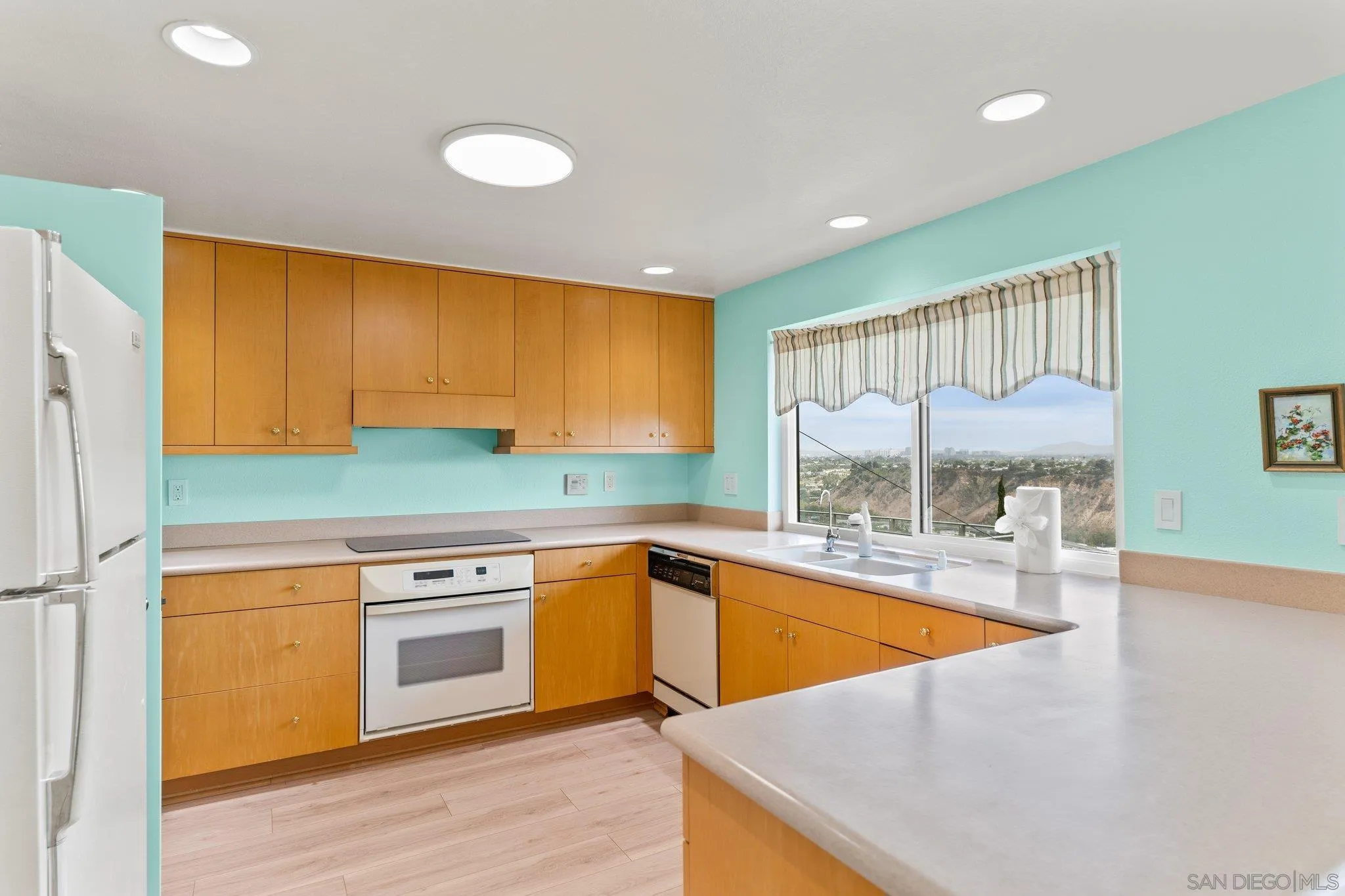 5668 Desert View Drive La Jolla, CA 92037 - Photo 6 of 23 a kitchen with stainless steel appliances granite countertop a sink and cabinets