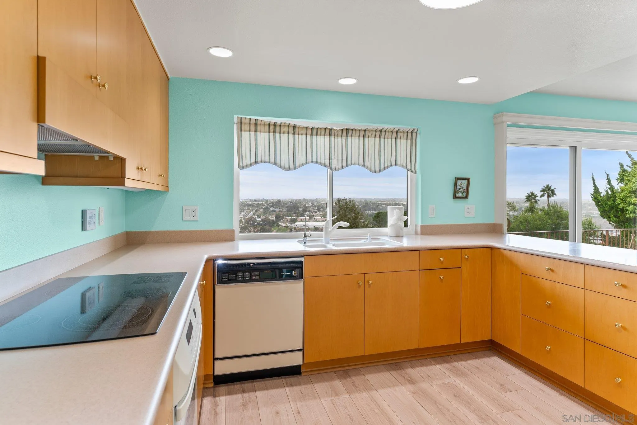 5668 Desert View Drive La Jolla, CA 92037 - Photo 7 of 23 a kitchen with a sink and a stove top oven