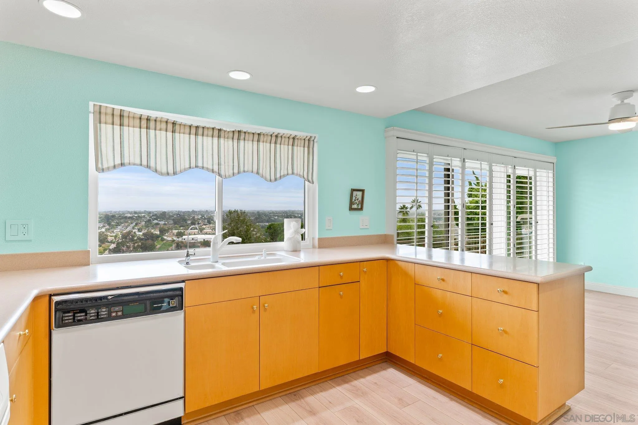 5668 Desert View Drive La Jolla, CA 92037 - Photo 8 of 23 a view of a kitchen with a fridge and wooden floor