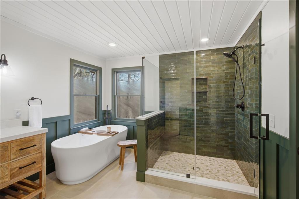 a bathroom with a shower a mirror and a sink