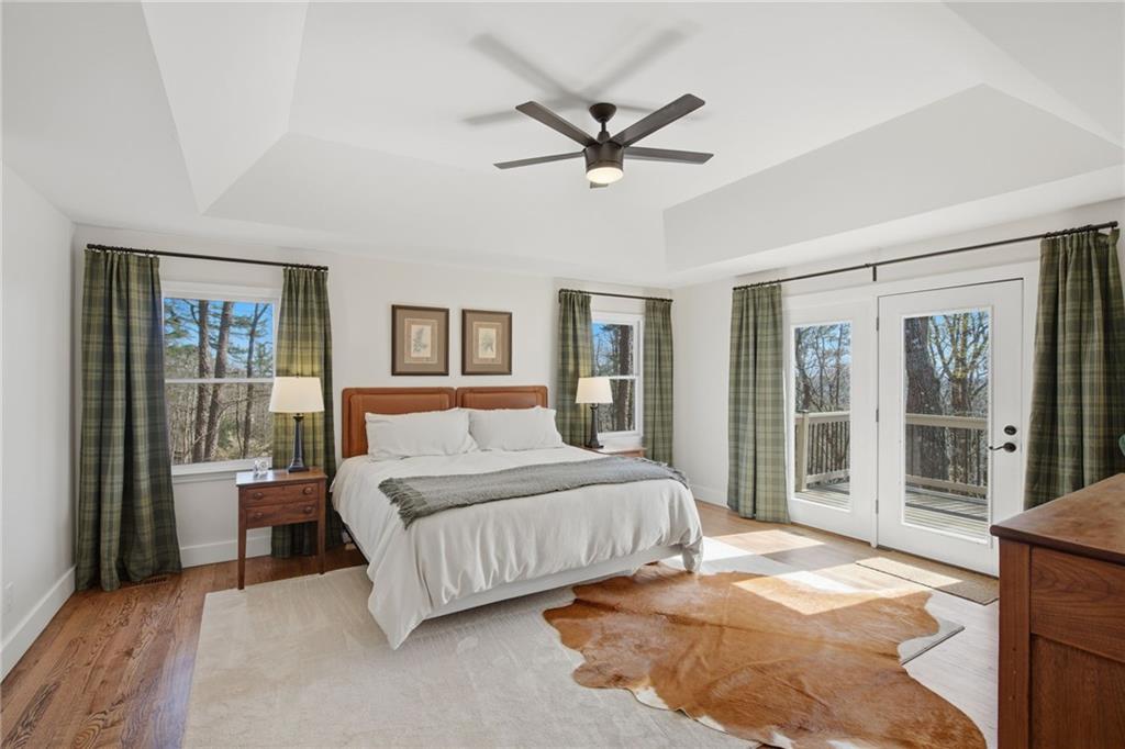 43 Morgan Walk Big Canoe, GA 30143 - Photo 22 of 66 a bedroom with a large bed and a chandelier fan
