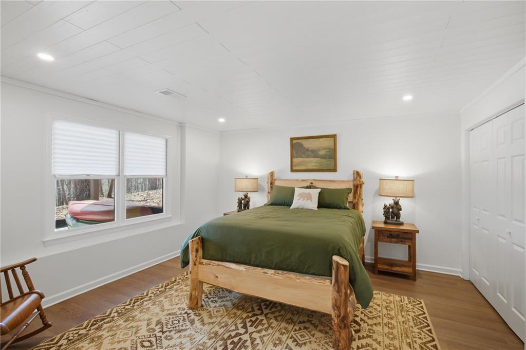 43 Morgan Walk Big Canoe, GA 30143 - Photo 31 of 66 a bedroom with a bed and wooden floor