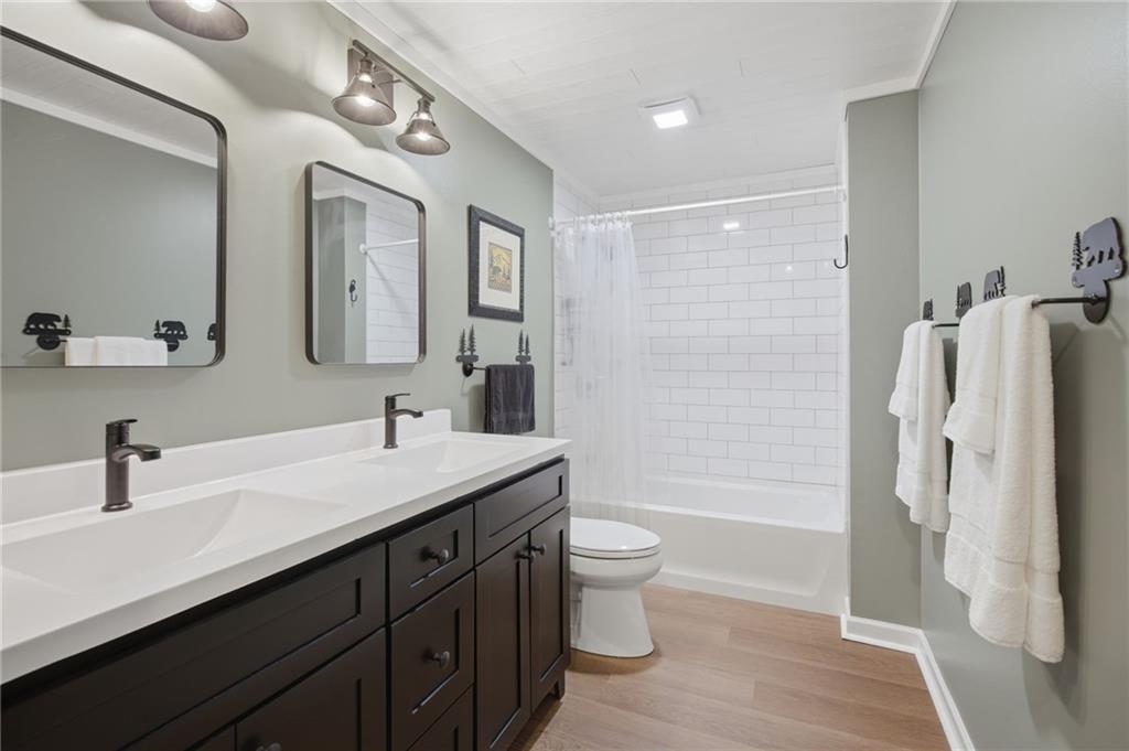 43 Morgan Walk Big Canoe, GA 30143 - Photo 33 of 66 a bathroom with a double vanity sink toilet mirror and shower