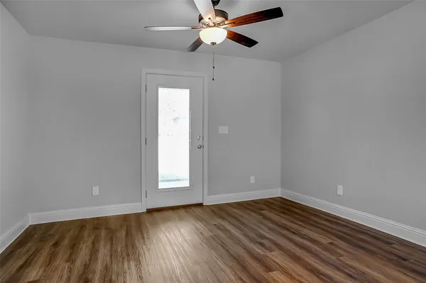wooden floor in an empty room with a window