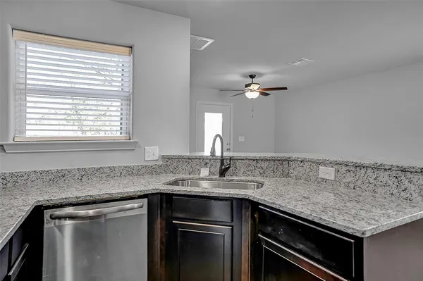 a kitchen with a sink and stove