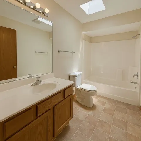 a bathroom with a sink toilet a mirror and shower