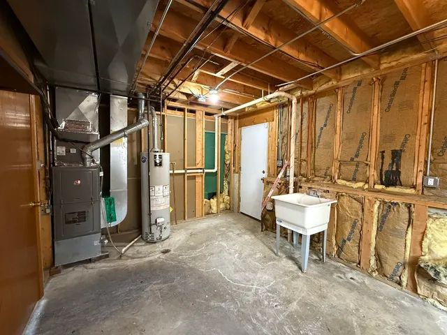 a view of a small house with garage