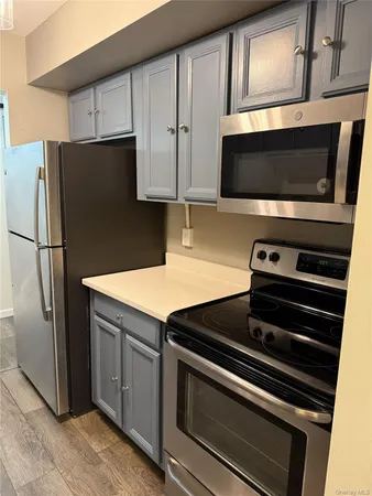 a kitchen with stainless steel appliances a stove a microwave and a refrigerator
