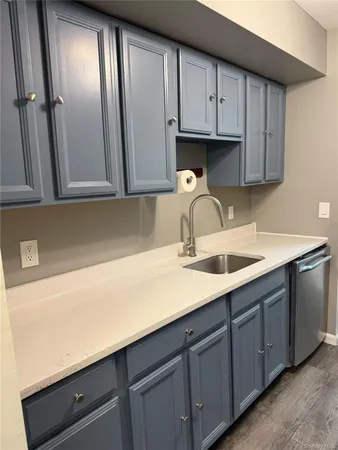 a kitchen with stainless steel appliances granite countertop a sink a refrigerator and cabinets