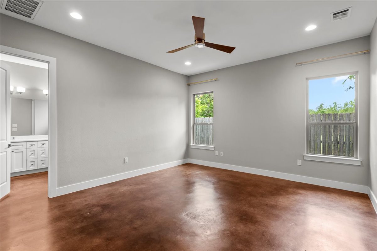 913 Stobaugh Street, Unit B Austin, TX 78757 - Photo 23 of 40 A quiet primary bedroom retreat with durable stained concrete flooring and ample natural light.