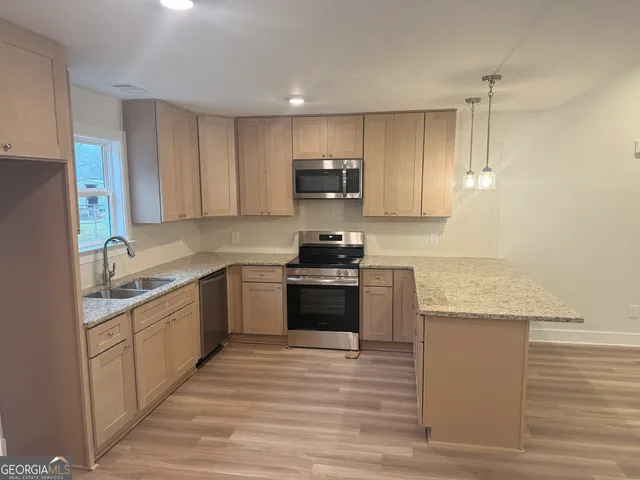 a kitchen with a sink stove and refrigerator