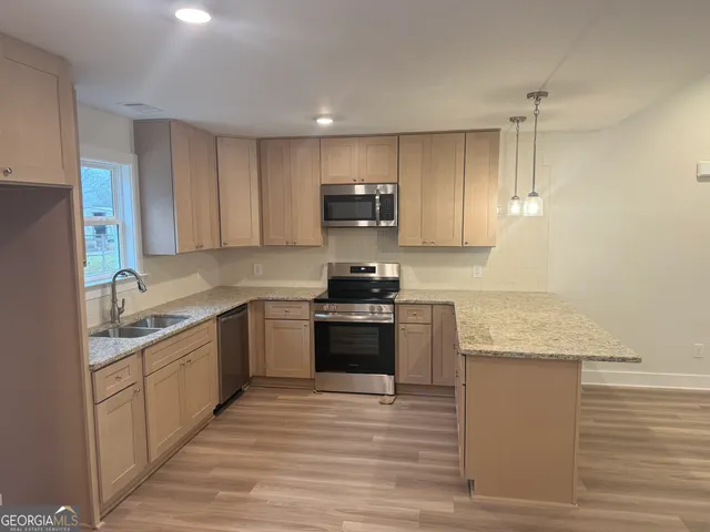 a kitchen with a sink stove and refrigerator