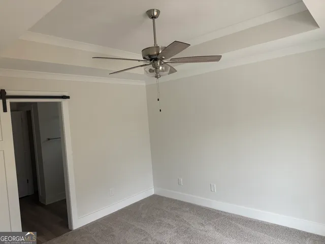 a room with a ceiling fan and a window