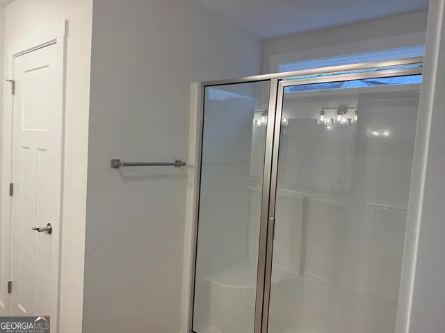 a bathroom with a glass shower door