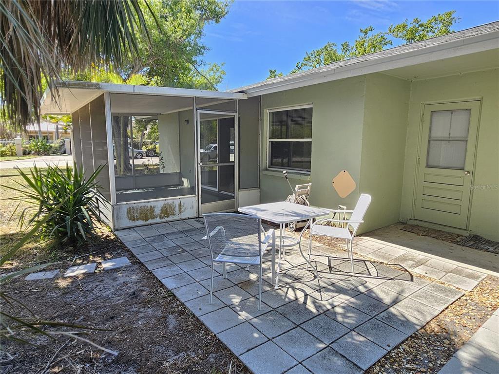 105 Base Avenue East Venice, FL 34285 - Photo 14 of 31 a view of a patio with table and chairs and potted plants