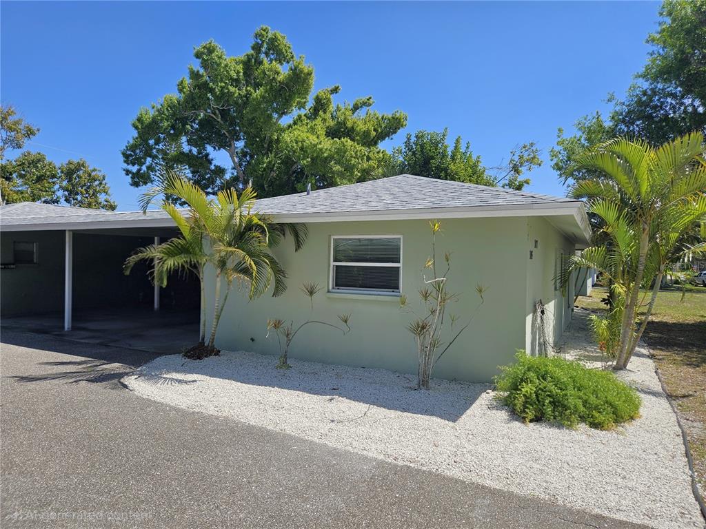 105 Base Avenue East Venice, FL 34285 - Photo 3 of 31 a front view of a house with a yard and garage