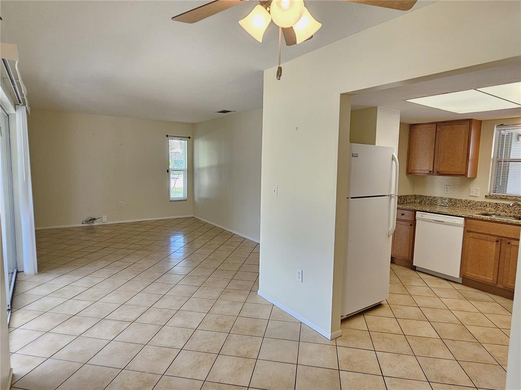 105 Base Avenue East Venice, FL 34285 - Photo 6 of 31 a view of a kitchen with a sink and refrigerator