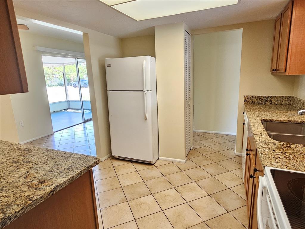 105 Base Avenue East Venice, FL 34285 - Photo 7 of 31 a kitchen with a refrigerator and a stove top oven