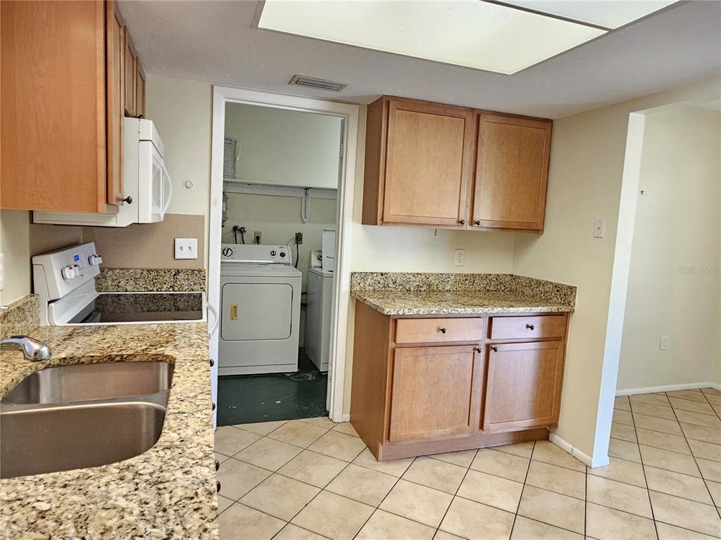 105 Base Avenue East Venice, FL 34285 - Photo 10 of 31 a kitchen with granite countertop a sink stove and cabinets