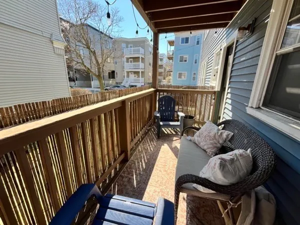 a balcony with table and chairs