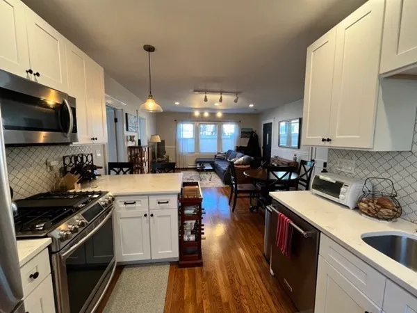 a kitchen with a sink stove and cabinets