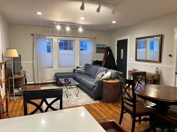 a living room with furniture a rug and a flat screen tv