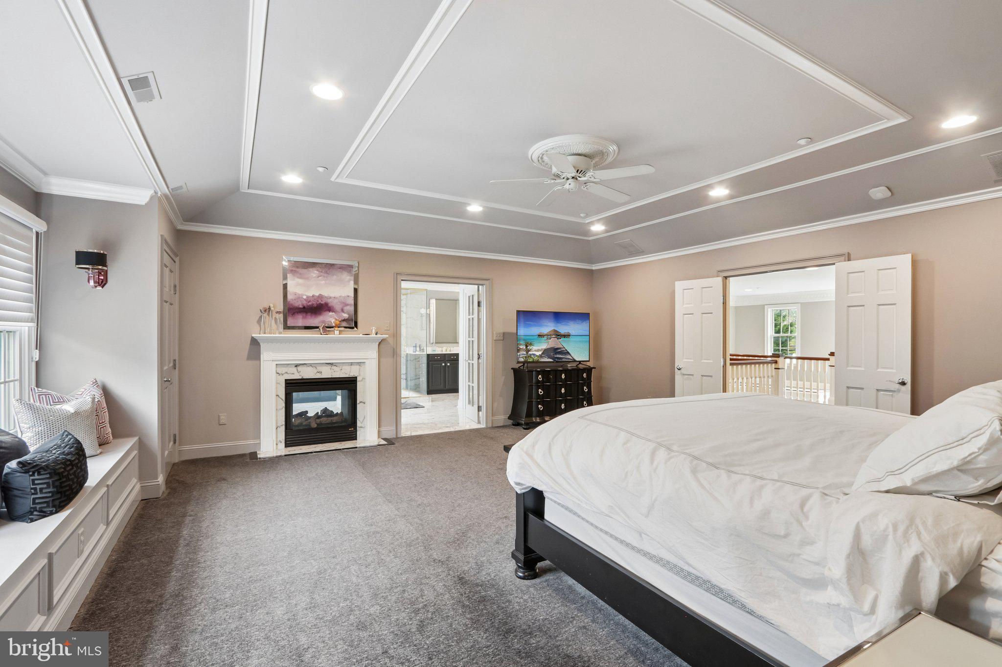 209 Welsh Road Ambler, PA 19002 - Photo 33 of 80 a spacious bedroom with a bed and a fireplace