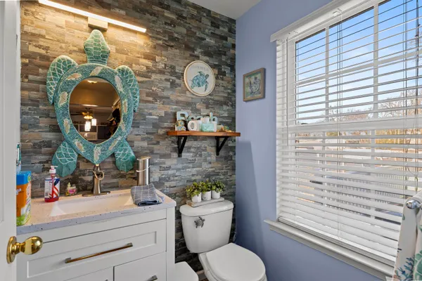 a bathroom with a toilet and a mirror