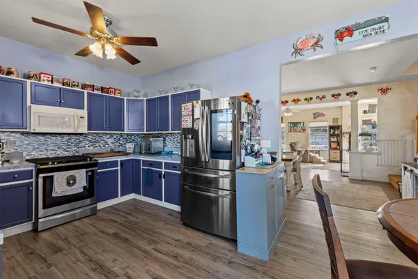 a kitchen with stainless steel appliances granite countertop a refrigerator a stove and a sink