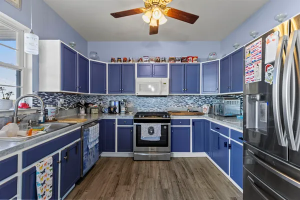 a kitchen with stainless steel appliances granite countertop a stove and cabinets