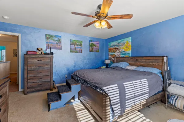 a bedroom with a bed and a chandelier
