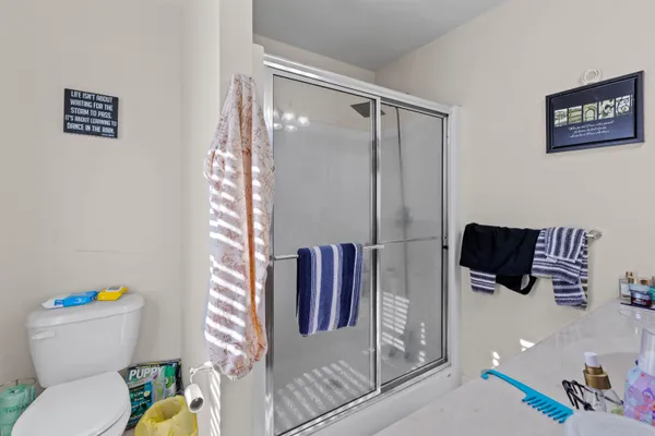 a bathroom with a toilet and a shower