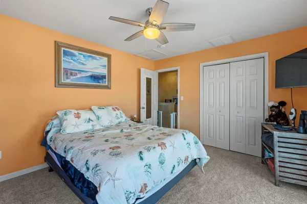 a spacious bedroom with a bed and a chandelier