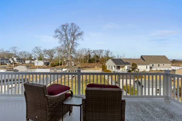 a view of a balcony with two chairs and a table