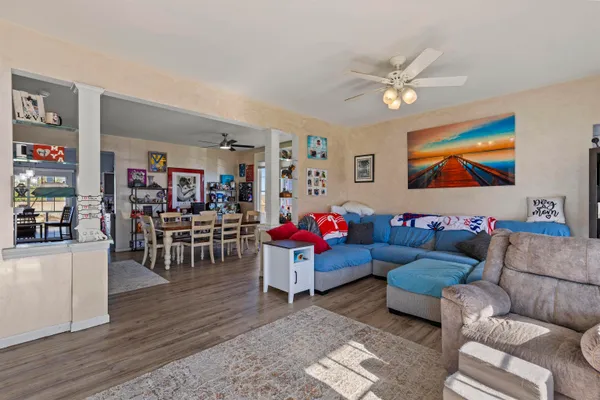 a living room with furniture and wooden floor